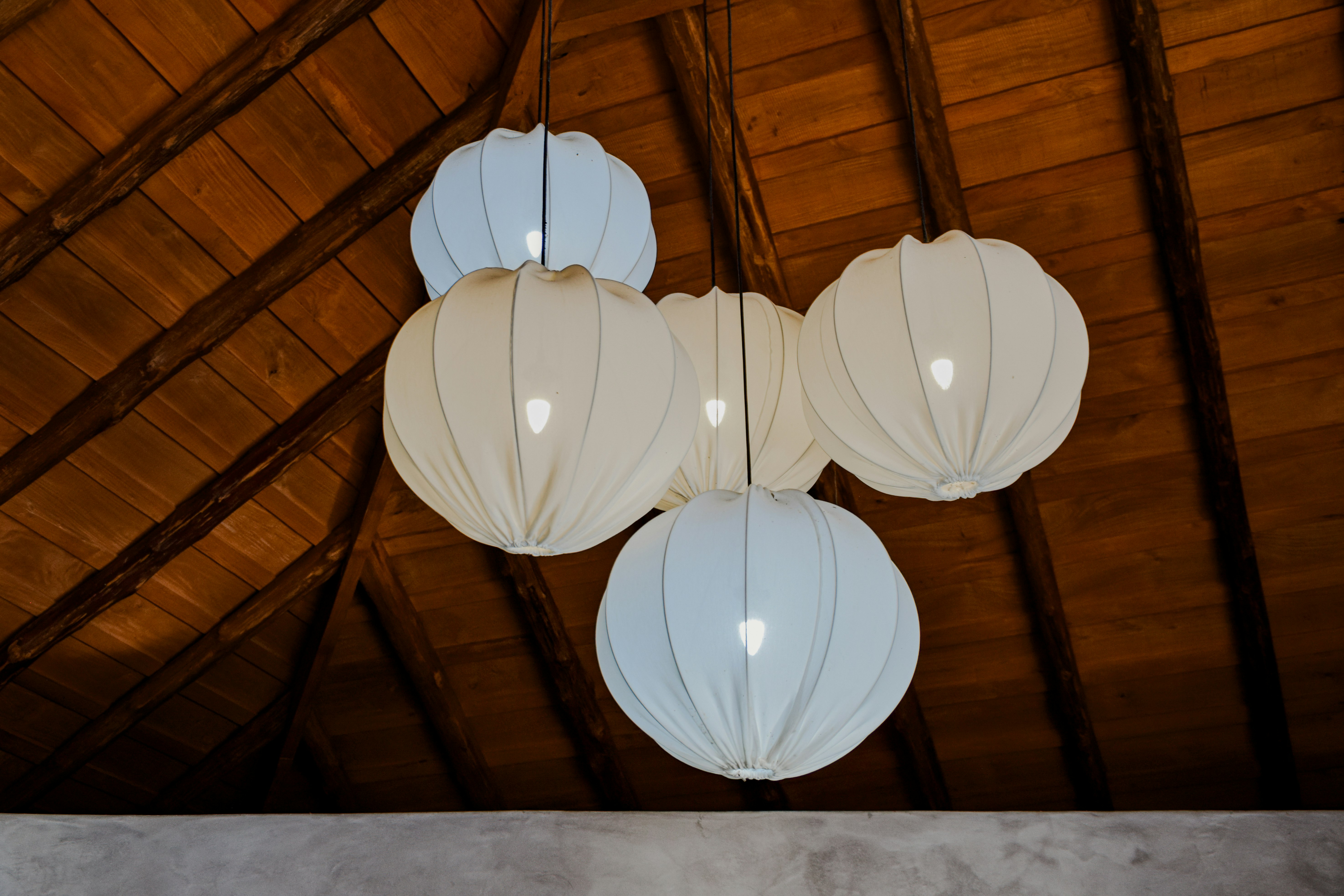 white paper lantern on brown wooden ceiling